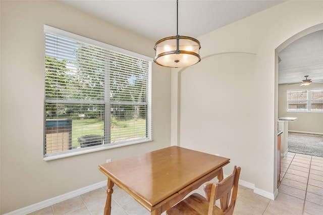 dining room with light tile patterned floors and ceiling fan