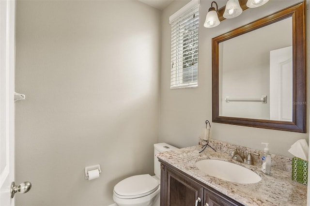 bathroom with toilet and vanity