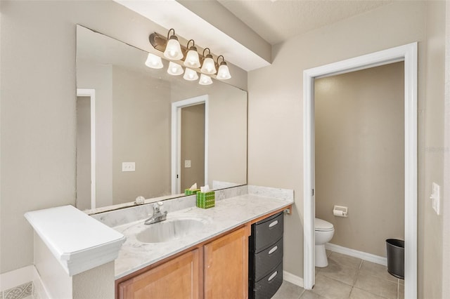 bathroom with tile patterned flooring, a textured ceiling, vanity, and toilet