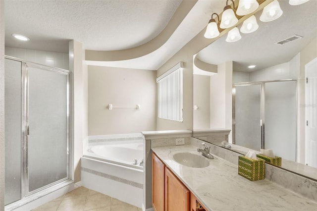 bathroom featuring tile patterned floors, a textured ceiling, plus walk in shower, and vanity