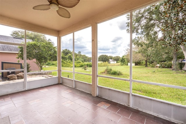 unfurnished sunroom with ceiling fan