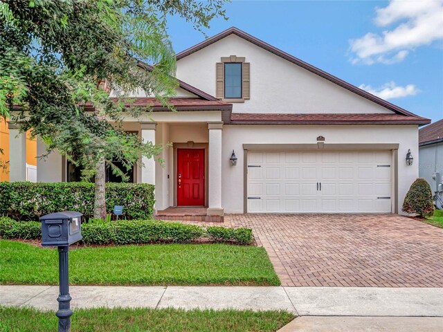 view of front of home featuring a garage and a front yard