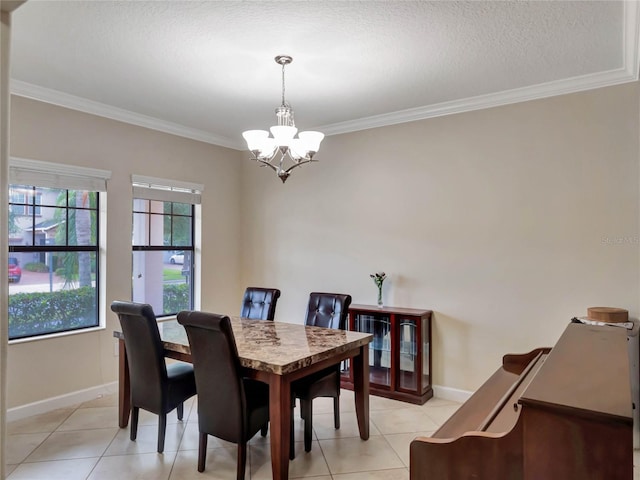 dining area with a textured ceiling, a notable chandelier, light tile patterned floors, and ornamental molding