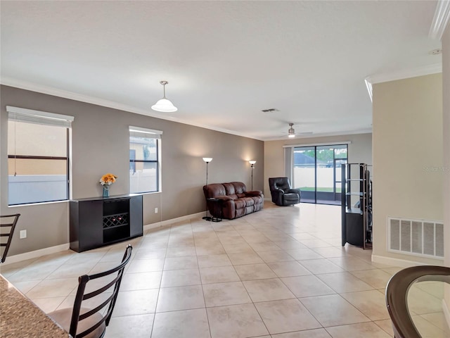 living room with light tile patterned floors, crown molding, and ceiling fan