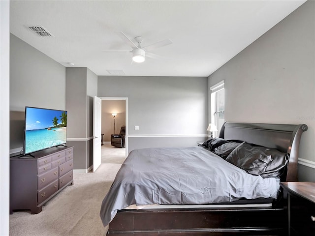 bedroom featuring light carpet, ceiling fan, and visible vents