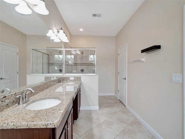 bathroom with dual vanity, tile patterned floors, and a shower with door