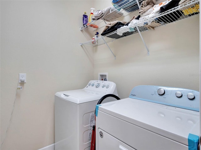 washroom featuring laundry area and washing machine and dryer