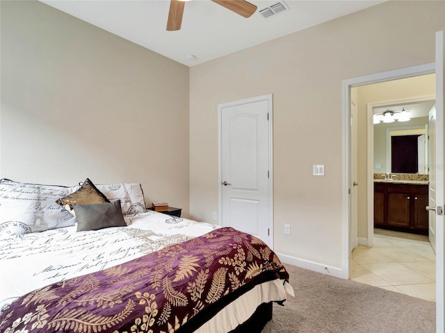 bedroom featuring ceiling fan, light tile patterned floors, light carpet, visible vents, and baseboards