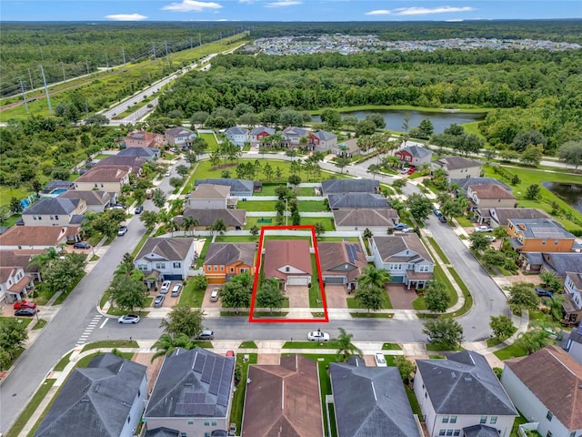 aerial view with a water view, a residential view, and a view of trees