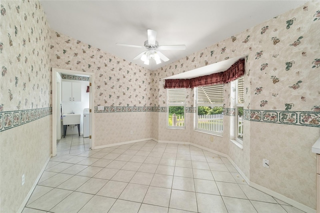 tiled spare room with sink, washer / clothes dryer, and ceiling fan