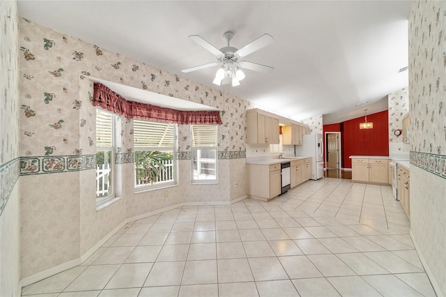 kitchen featuring sink, stainless steel dishwasher, light brown cabinetry, and light tile patterned floors