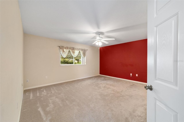 empty room featuring ceiling fan and light carpet