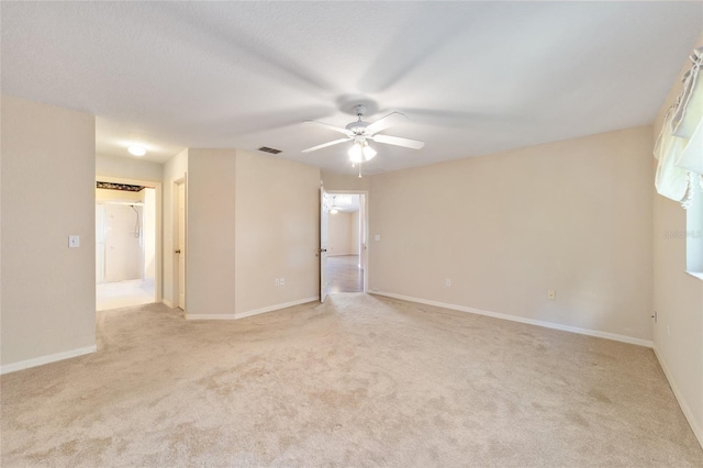 empty room featuring light carpet and ceiling fan