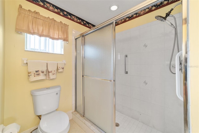 bathroom with an enclosed shower and toilet