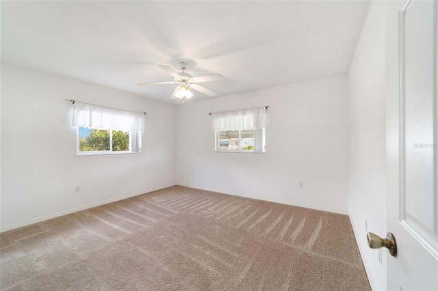 carpeted spare room with ceiling fan