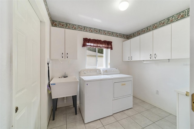 clothes washing area with light tile patterned floors, independent washer and dryer, and cabinets