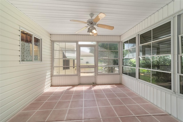 unfurnished sunroom featuring ceiling fan