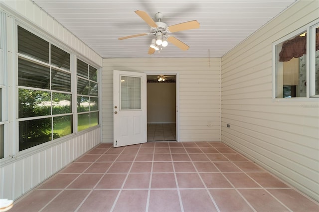 unfurnished sunroom with ceiling fan