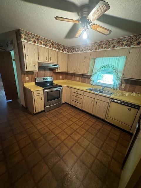 kitchen featuring ceiling fan, sink, a textured ceiling, and stainless steel range with electric cooktop