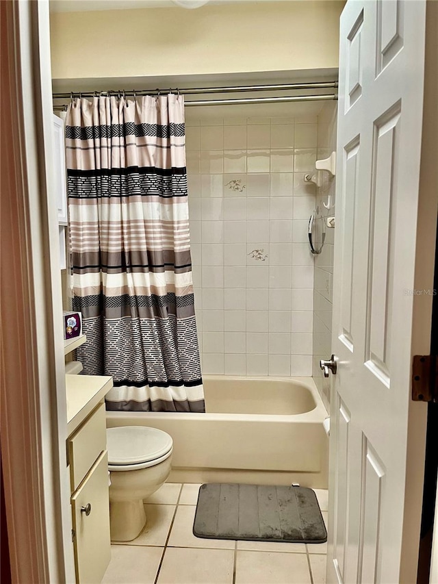 full bathroom featuring shower / bathtub combination with curtain, vanity, tile patterned flooring, and toilet