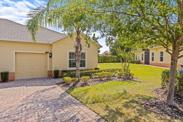 view of front of home with a front lawn and a garage