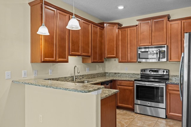 kitchen featuring kitchen peninsula, pendant lighting, light tile patterned floors, stainless steel appliances, and sink