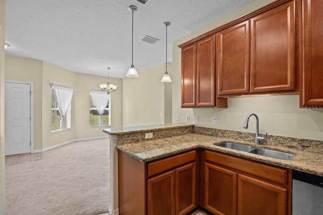 kitchen featuring a chandelier, light carpet, kitchen peninsula, and hanging light fixtures