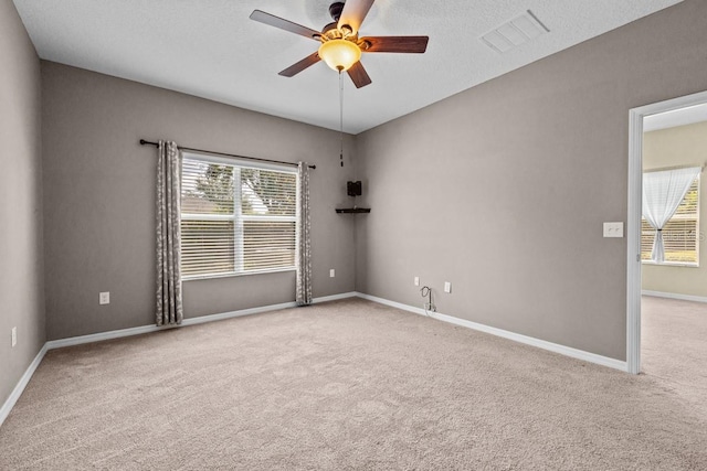 unfurnished room featuring carpet flooring, ceiling fan, and a healthy amount of sunlight