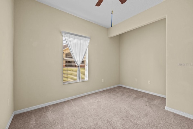 carpeted spare room with ceiling fan