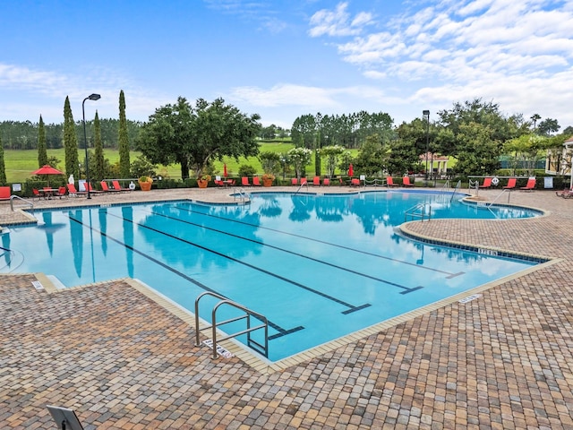 view of swimming pool with a patio area