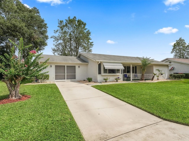 ranch-style home with a front yard, a garage, and covered porch