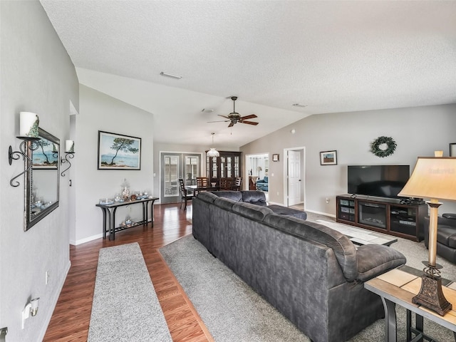 living room featuring french doors, dark hardwood / wood-style floors, vaulted ceiling, a textured ceiling, and ceiling fan