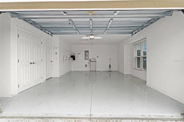 garage with a garage door opener and electric panel