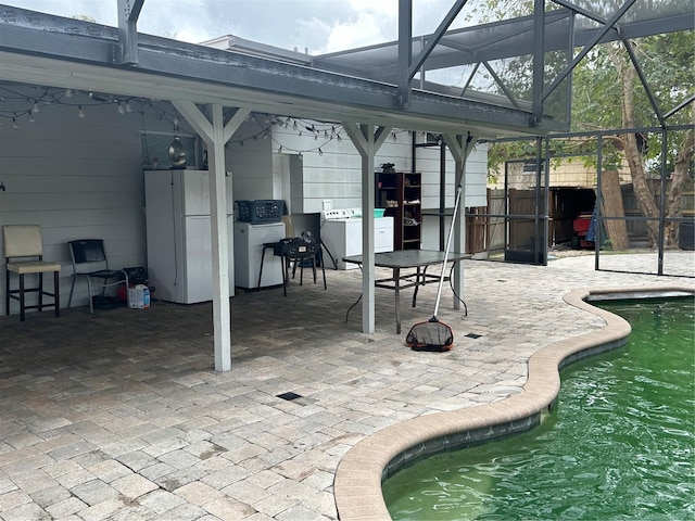 2524 Good Homes Rd, Orlando, FL 32818 - outdoor pool featuring a patio, washer / clothes dryer, and glass enclosure