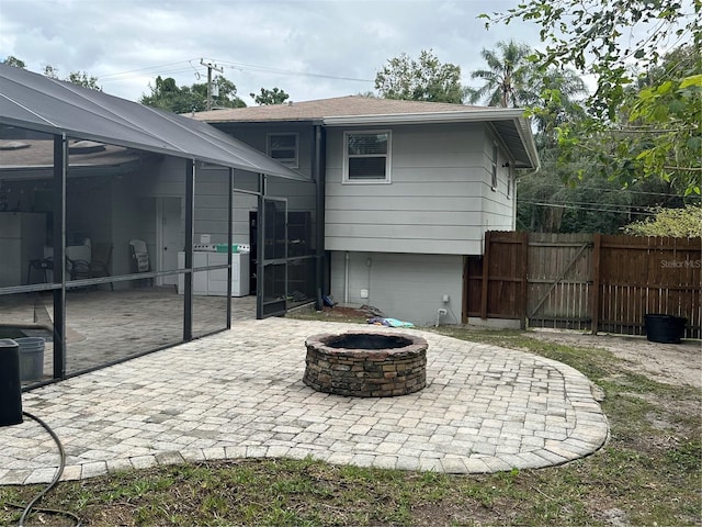2524 Good Homes Rd, Orlando, FL 32818 - back of house featuring a patio, an outdoor fire pit, a lanai, and a gate