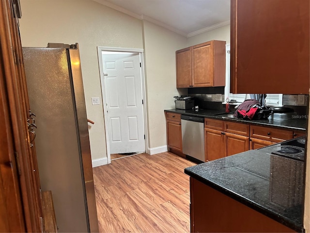 2524 Good Homes Rd, Orlando, FL 32818 - kitchen with appliances with stainless steel finishes, ornamental molding, light wood-style flooring, brown cabinets, and baseboards