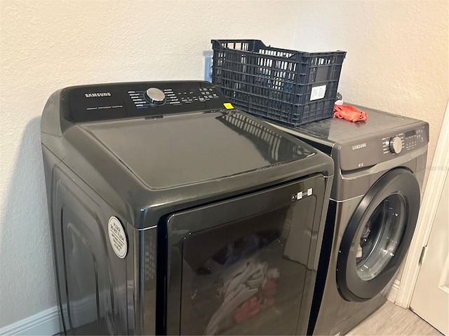 laundry area with independent washer and dryer