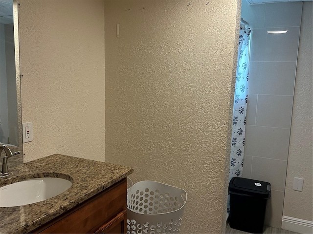 bathroom with vanity and walk in shower