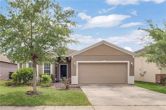 ranch-style home featuring a garage and a front yard