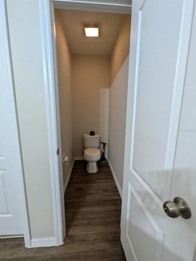 bathroom with hardwood / wood-style floors and toilet