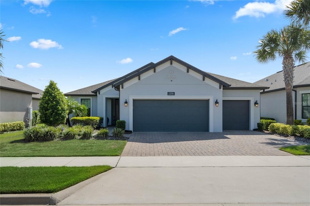 ranch-style home with a garage and a front lawn