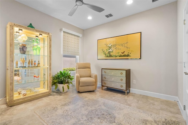 sitting room featuring ceiling fan and light tile patterned floors