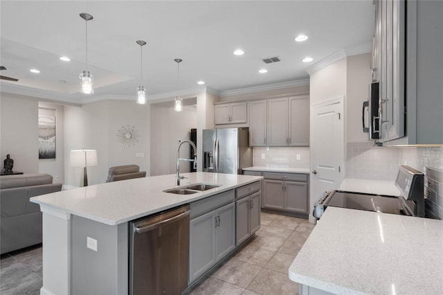 kitchen featuring stainless steel appliances, tasteful backsplash, sink, a kitchen island with sink, and light tile patterned flooring