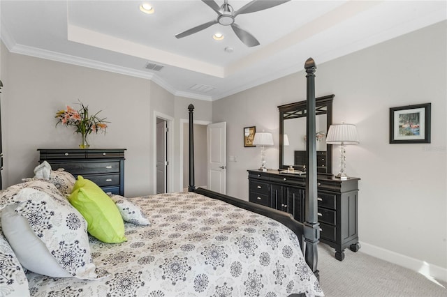 carpeted bedroom with ceiling fan, a raised ceiling, and ornamental molding