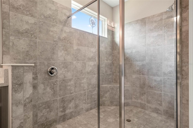 bathroom featuring a shower with door