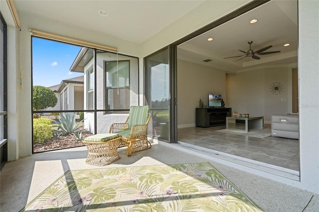 sunroom / solarium featuring ceiling fan