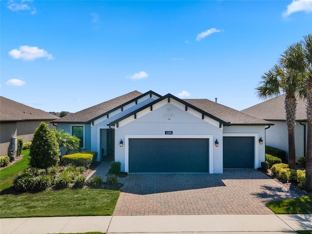 single story home with a garage and a front yard