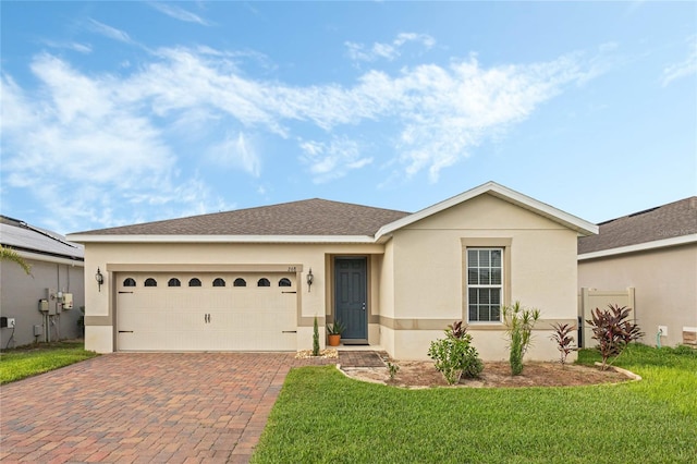 ranch-style house with a front lawn, solar panels, and a garage