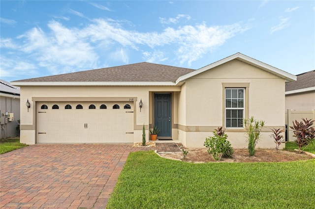 single story home featuring a front lawn and a garage