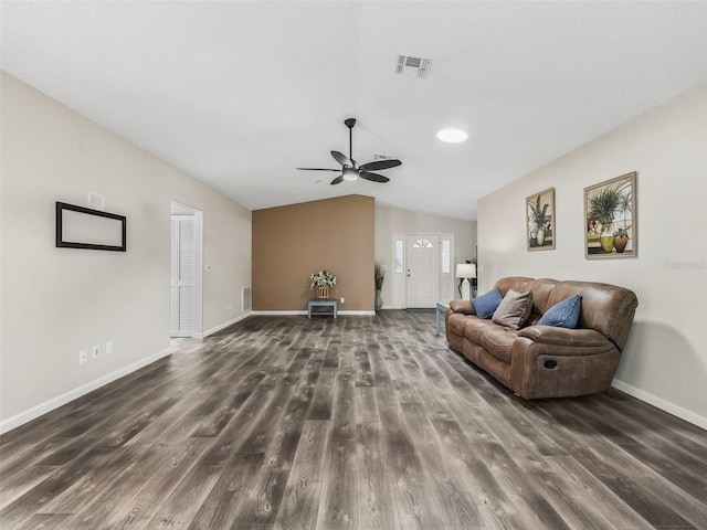 living room with wood finished floors, baseboards, vaulted ceiling, and visible vents